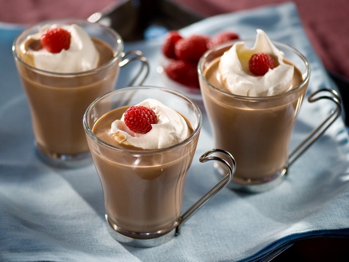 Chocolate pudding with whipped cream and raspberries