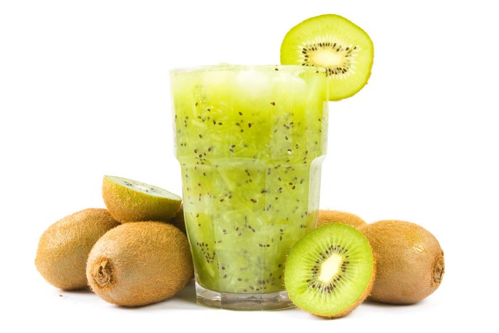 Kiwi smoothie in a highball glass with kiwis