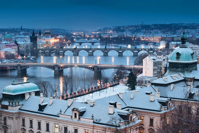 Prague cityscape with Charles Bridge and Vltava River in winter at night
