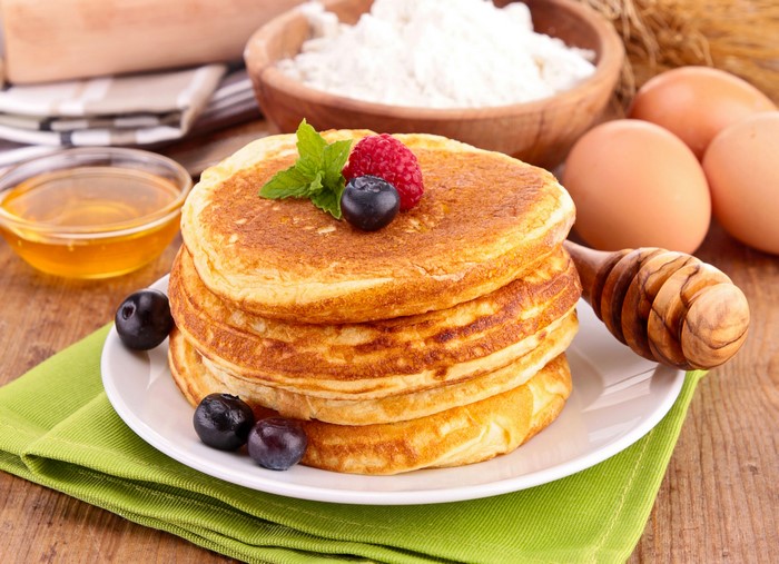 Stack of Pancakes with Berries and Honey