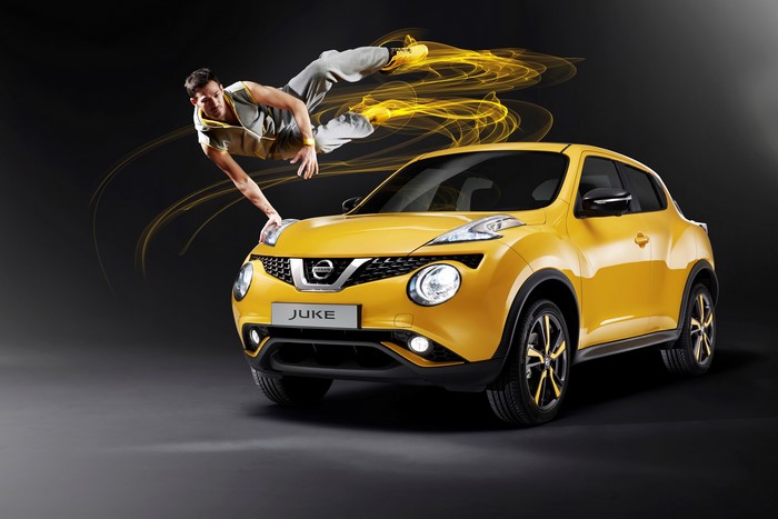 Man breakdancing on a yellow Nissan Juke