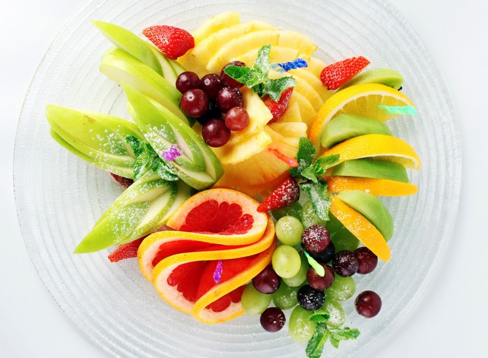 Fruit platter with strawberries, grapes, pineapple, citrus, and grapefruit