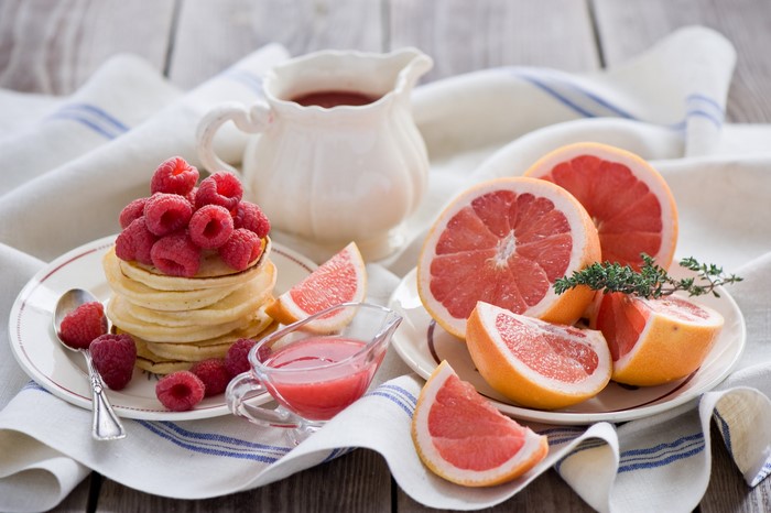 Pancakes with raspberries and grapefruit slices