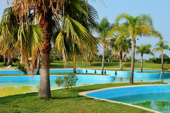 Palm trees and swimming pools in Corigliano Calabro, Italy