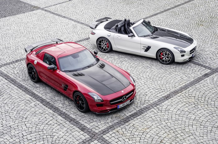 Two Mercedes-Benz SLS AMG GT cars on cobblestone