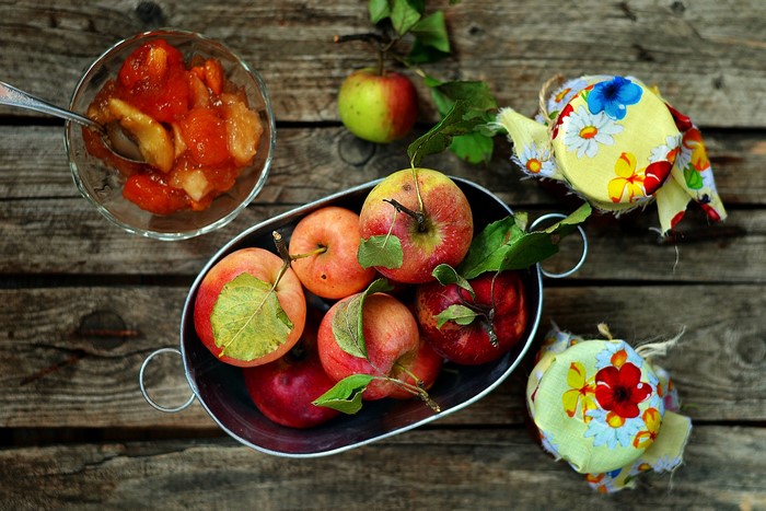 Apples and jam on a wooden table