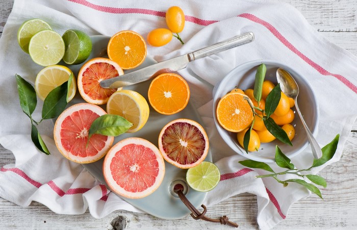 Assortment of Citrus Fruits on a White Cloth