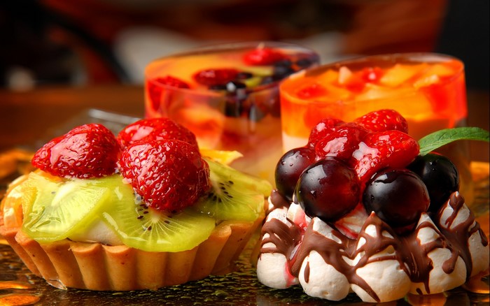 Fruit tarts and jelly desserts with berries