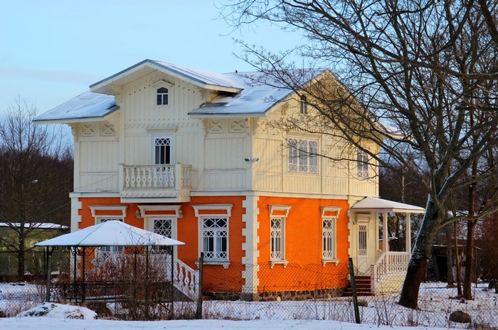 Orange and white house in winter near St. Petersburg, Russia