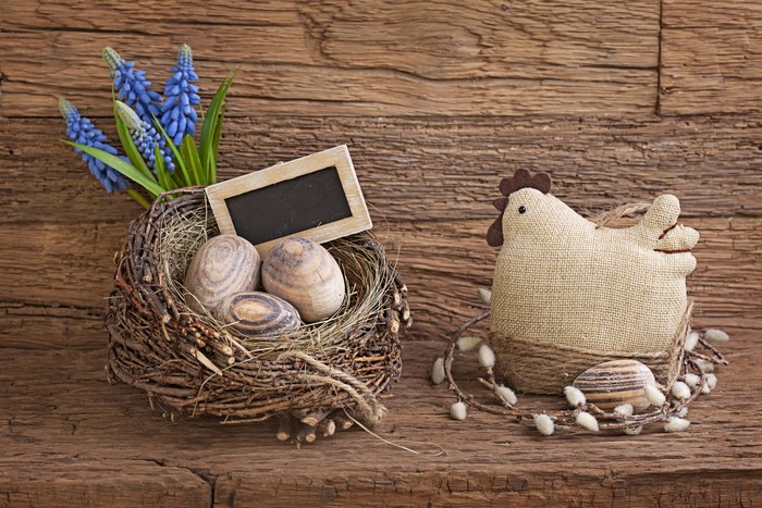Easter nest with eggs, flowers, and chicken decoration