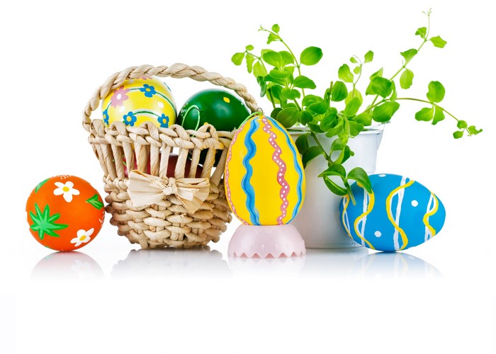 Easter eggs in a wicker basket with plants