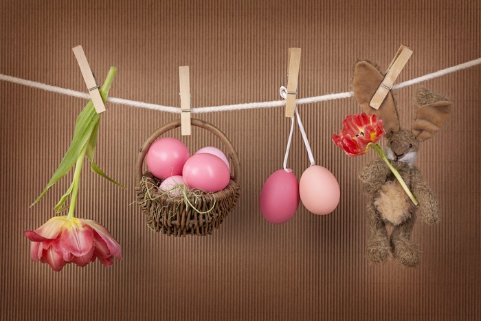 Easter eggs and tulips hanging on a clothesline with a bunny toy
