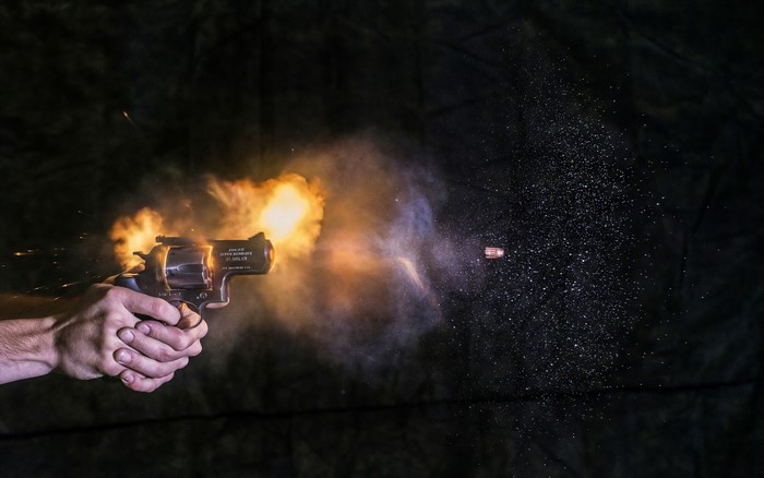Revolver firing a bullet with muzzle flash
