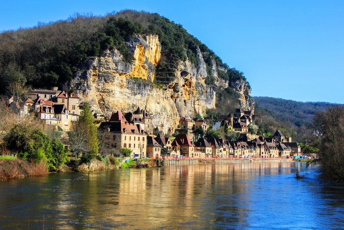 La Roque Gageac village on a cliff by a river in France
