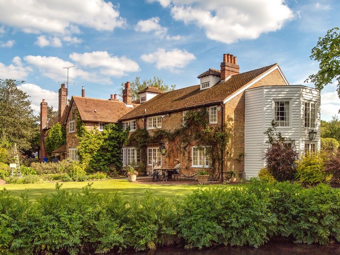 Brick house with white siding and garden in Hampshire, England