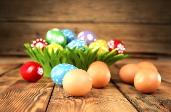 Easter Eggs in a Basket on a Wooden Table