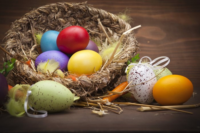 Easter eggs in a wicker basket with feathers