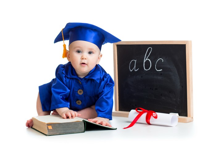 Baby in Graduation Gown with Book and Blackboard