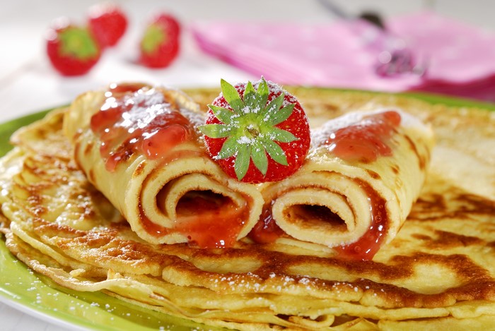 Pancakes with strawberry jam and strawberry topping