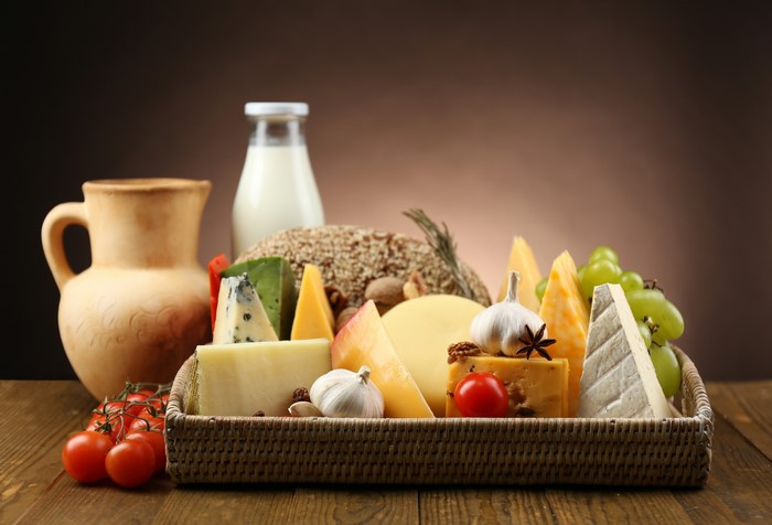 Still-life of cheese, milk, tomatoes, and garlic