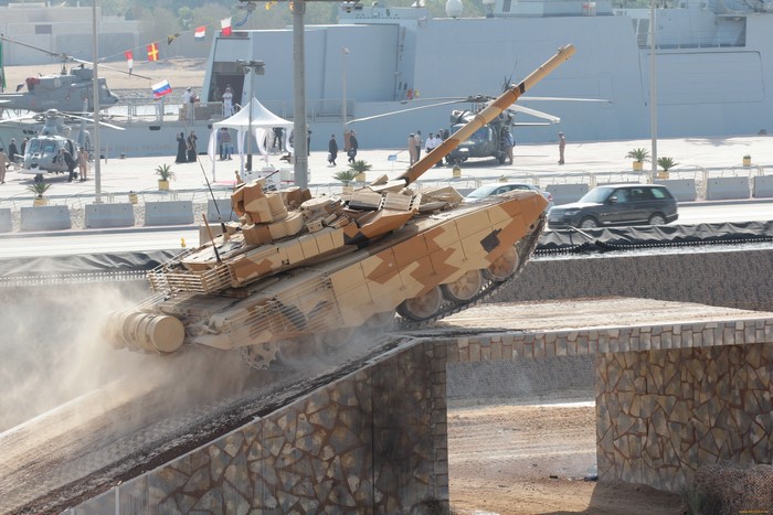 T-90 tank driving over an obstacle