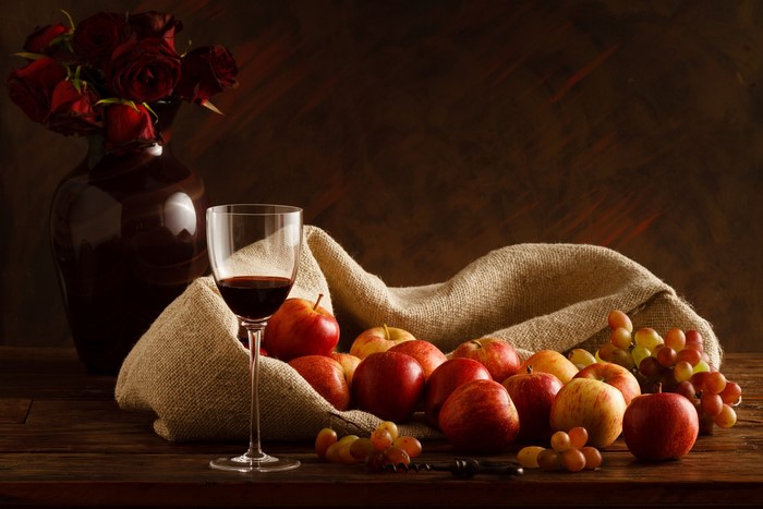 Still-life with apples, wine, grapes, roses, and vase
