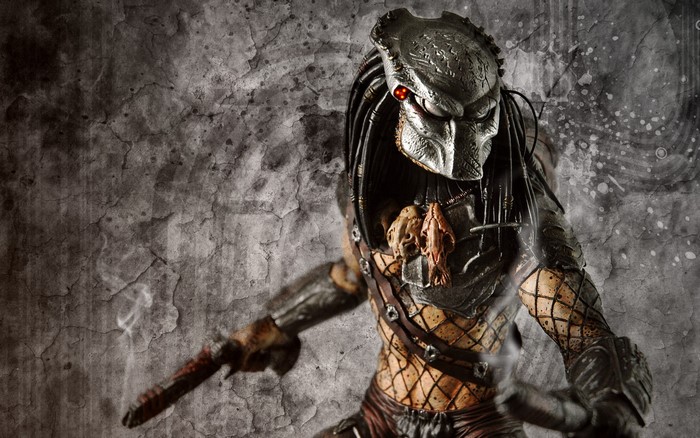 Predator warrior with skull necklace against textured background