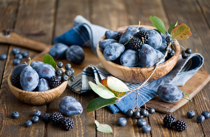 Plums, Blueberries, and Blackberries in Wooden Bowls