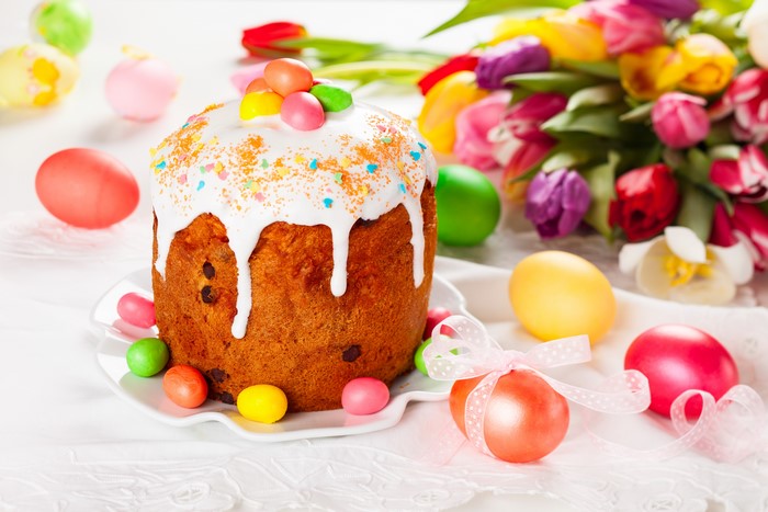 Easter Kulich with Icing and Eggs and Tulips