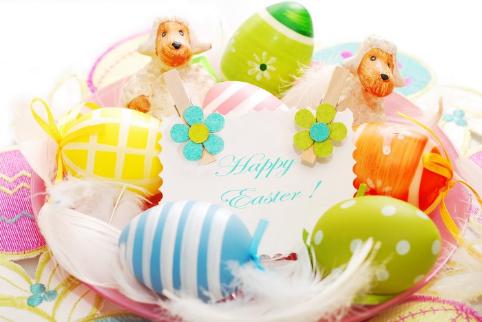 Happy Easter decorated eggs and sheep figurines