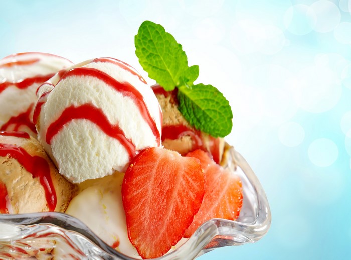 Ice cream sundae with strawberries and mint