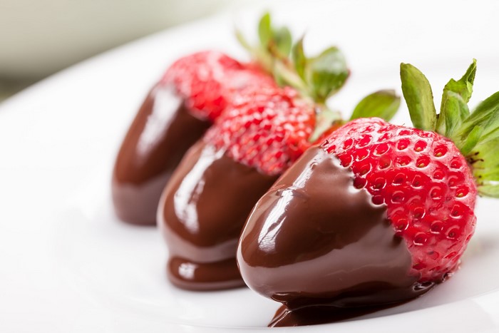 Chocolate-dipped strawberries on a white plate