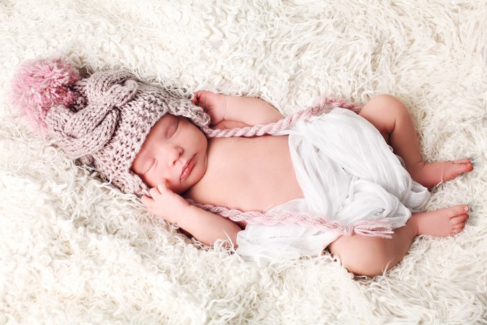 Newborn baby sleeping in a knitted hat
