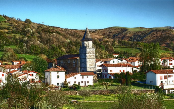 Village with church tower and rolling hills
