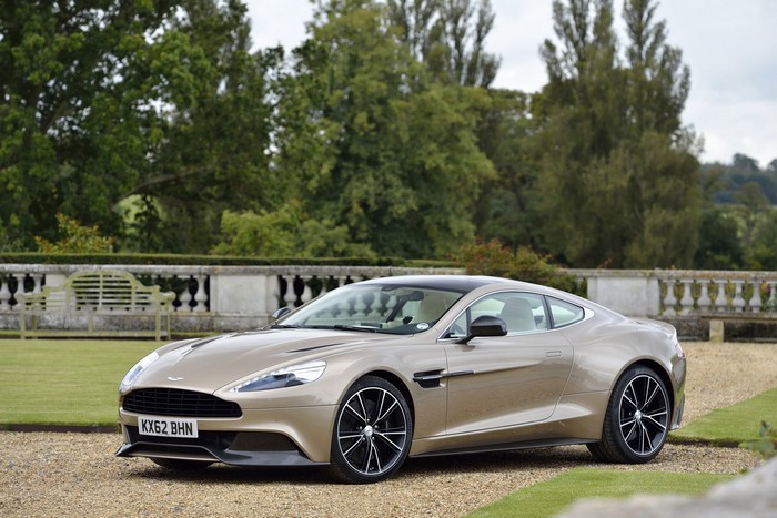 Aston Martin Vanquish parked on gravel in front of a garden