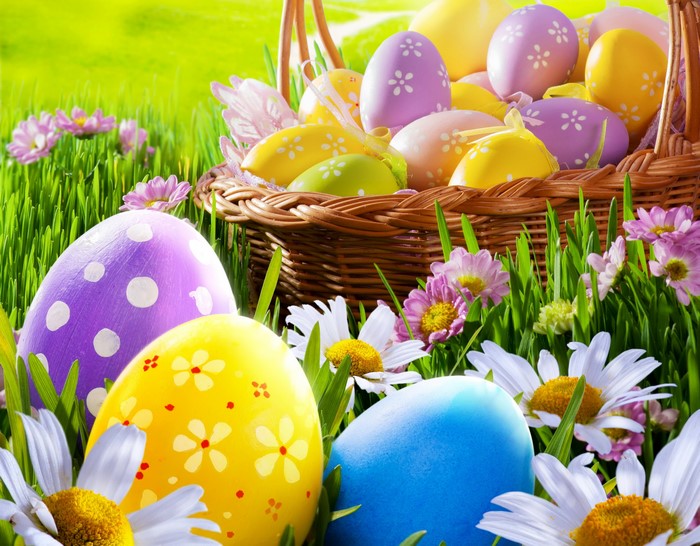Easter eggs in a wicker basket with flowers