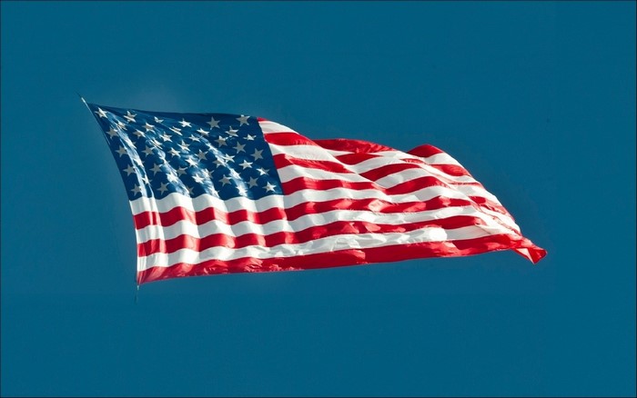 American Flag Waving in Blue Sky