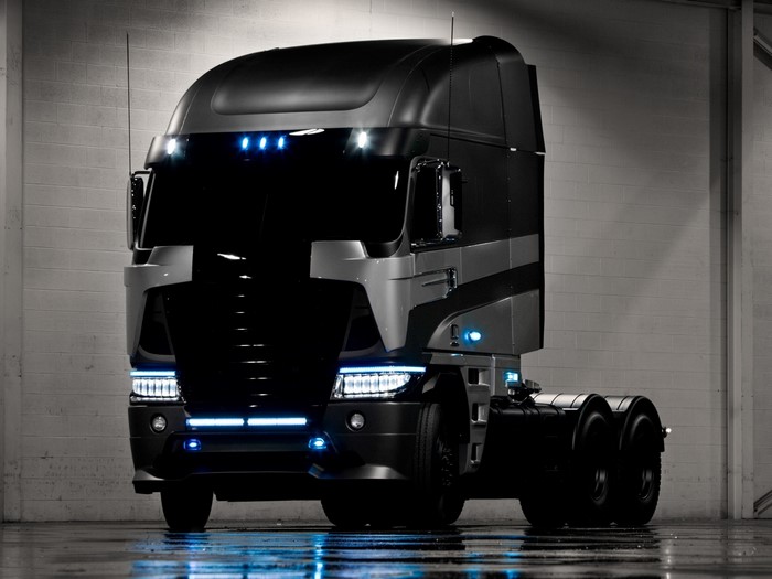 Black Freightliner Cascadia semi-truck with blue lights
