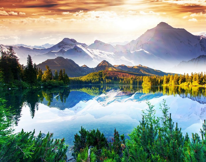 Lake and snow-capped mountains at sunset
