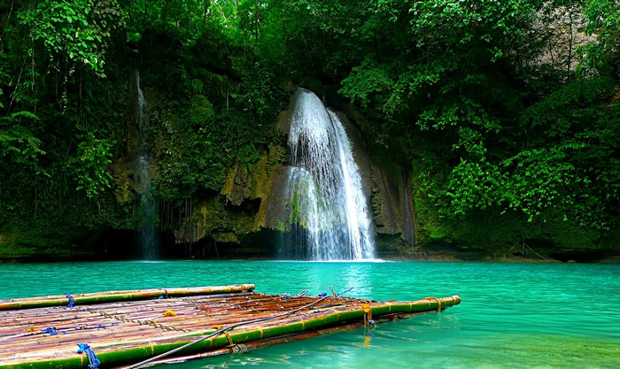 Waterfall in Badian, Philippines with Bamboo Raft