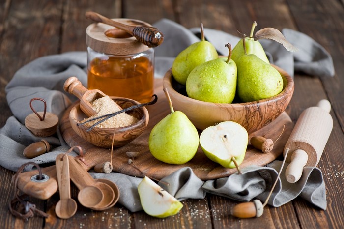 Pears, Honey, and Baking Ingredients on Wooden Table
