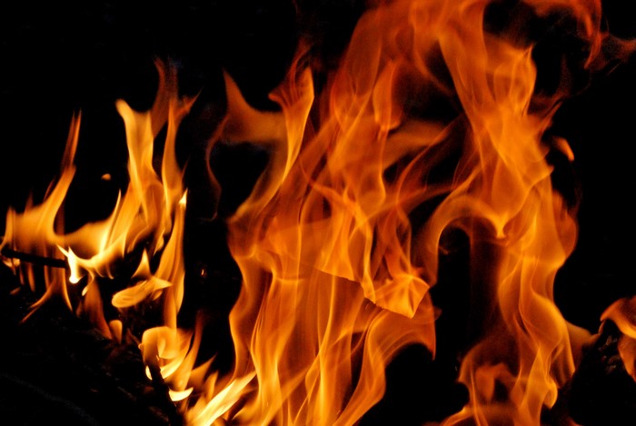 Close-up of orange flames against black background