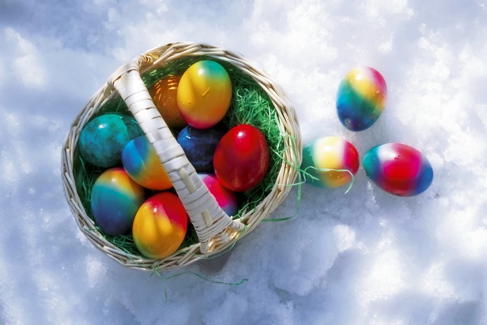 Easter Eggs in a Wicker Basket on Snow