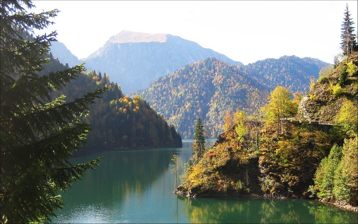 Lake Ritsa in Abkhazia, Georgia, surrounded by mountains in autumn