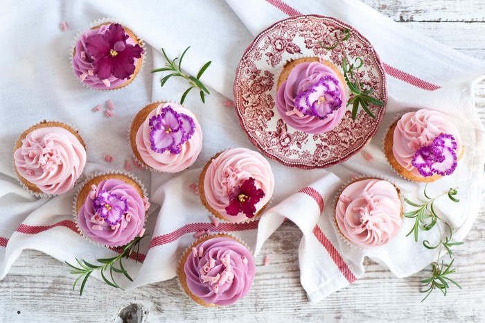 Cupcakes with pink and purple frosting and flowers