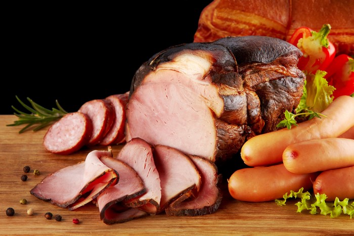 Assortment of cured meats and sausages on a wooden board