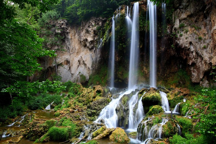 Waterfall cascading over mossy rocks in a forest