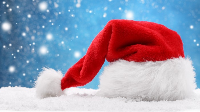 Santa hat in snow with snowflakes