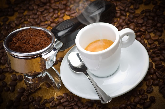 Espresso cup with coffee beans and grounds