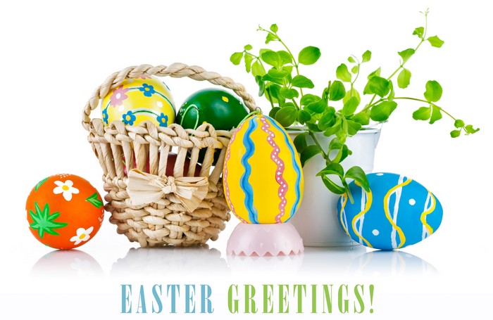 Easter Eggs in Wicker Basket with Greenery